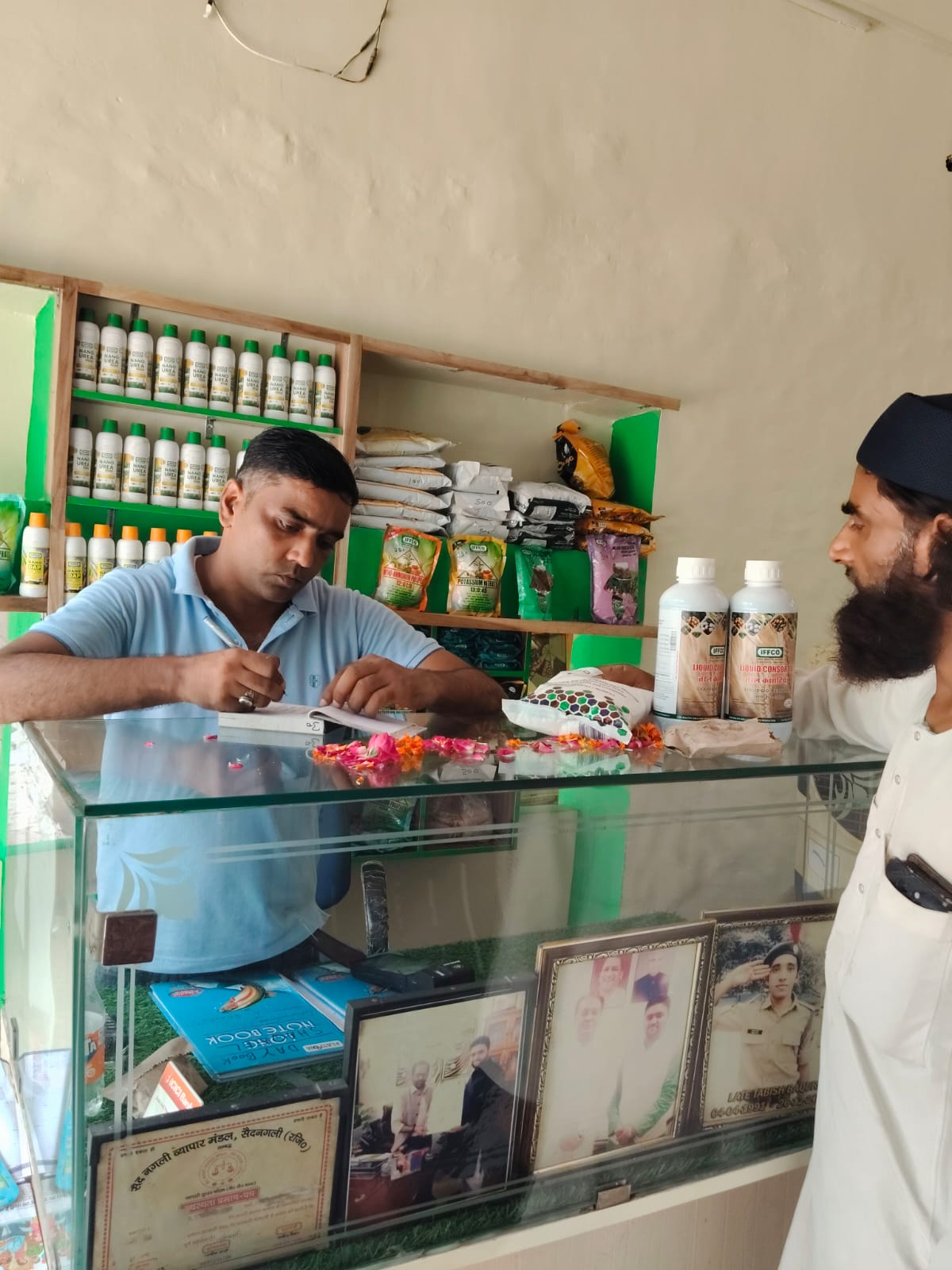 Farmer being served at the fertiliser sales counter of a service centre