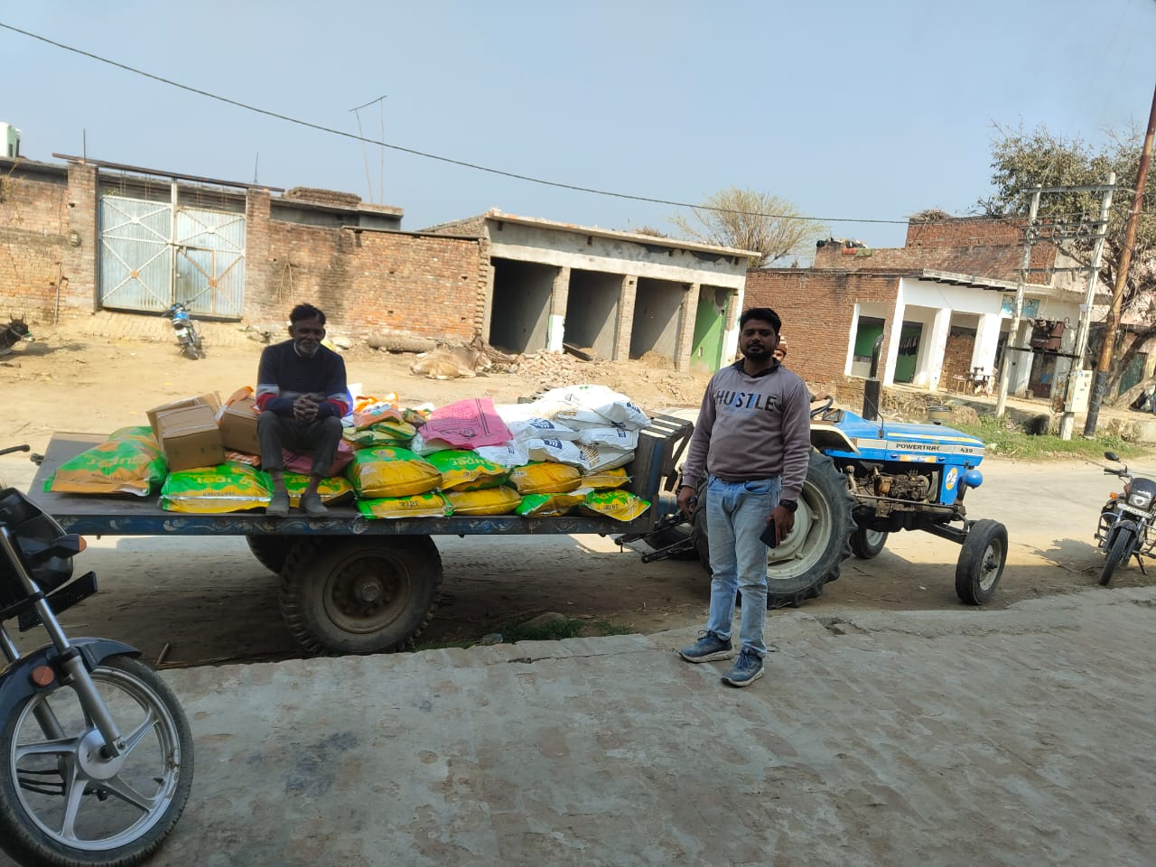 Fertiliser consignment loaded on a tractor trolley for village delivery